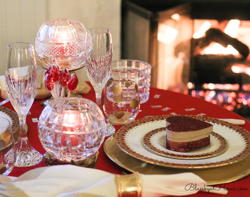 red and gold Valentine table in front of fireplace