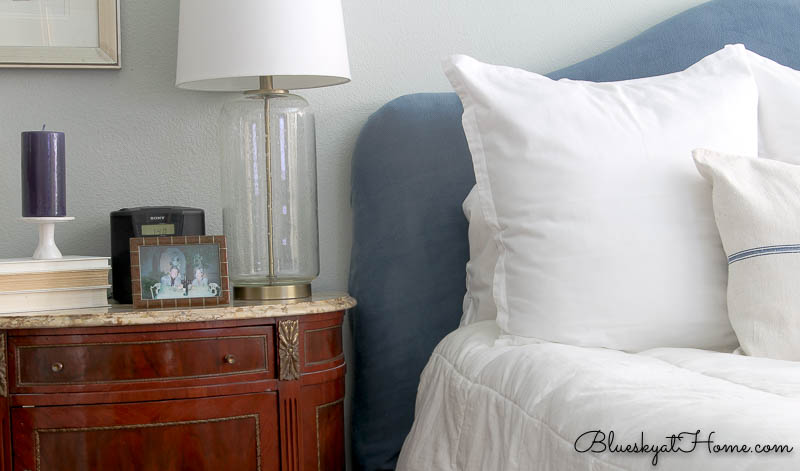 blue headboard with white pillows