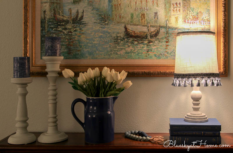 lamp at night with blue pitcher and white tulips