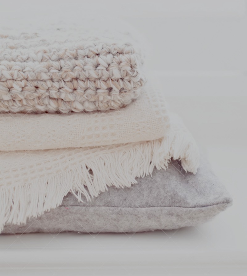 stack of winter blankets and pillow