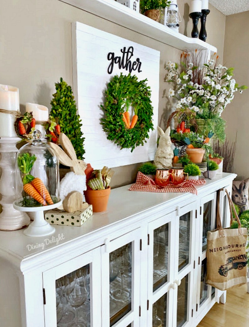 Easter hutch with bunnies, orange carrots and wreath