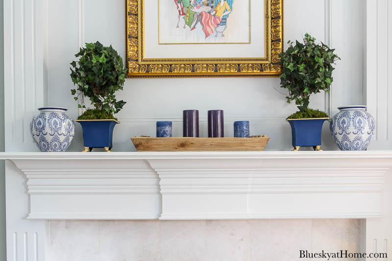 blue painted planter and blue vase on mantel