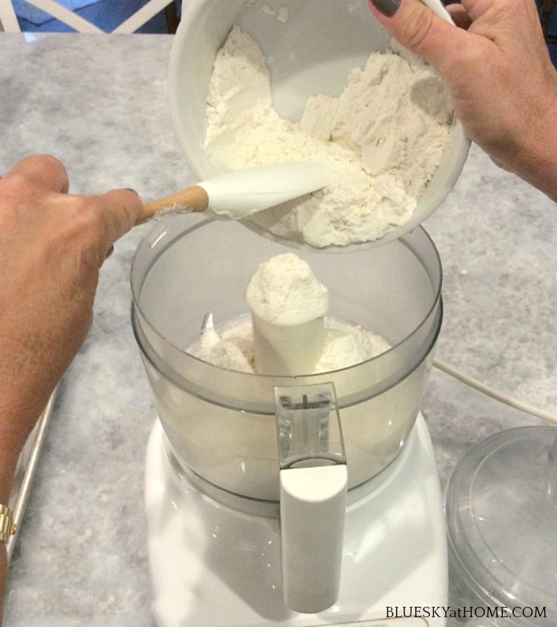 adding flour to food processor