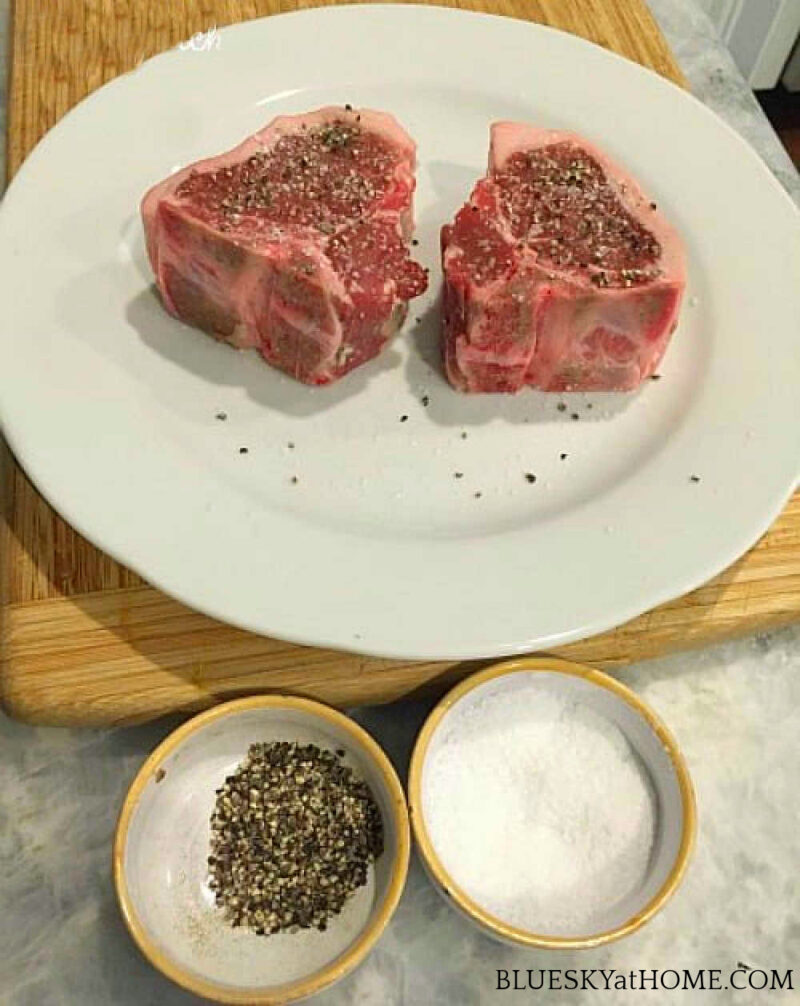 two lamb loin chops on a white plate