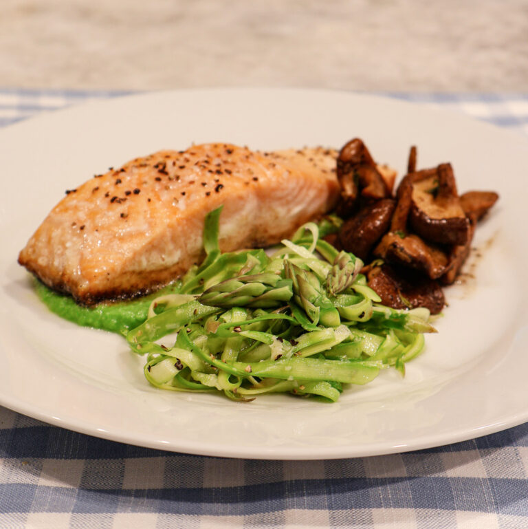 pan-seared salmon on a pea sauce with asparagus crudo and roasted mushrooms