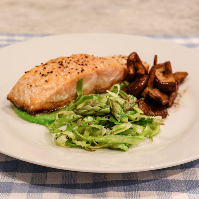 pan-seared salmon on a pea sauce with asparagus crudo and roasted mushrooms