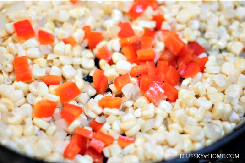 corn and diced tomoates in skillet for creamed corn