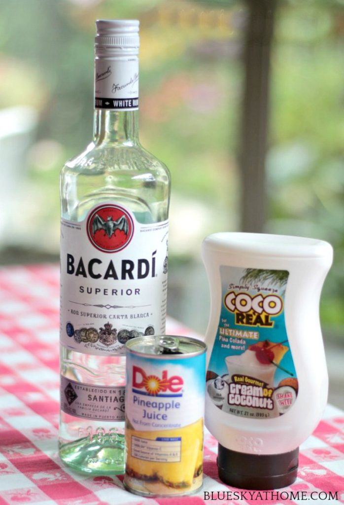 ingredients for pina colada bottle of rum, can of pineapple juice and coco lopez