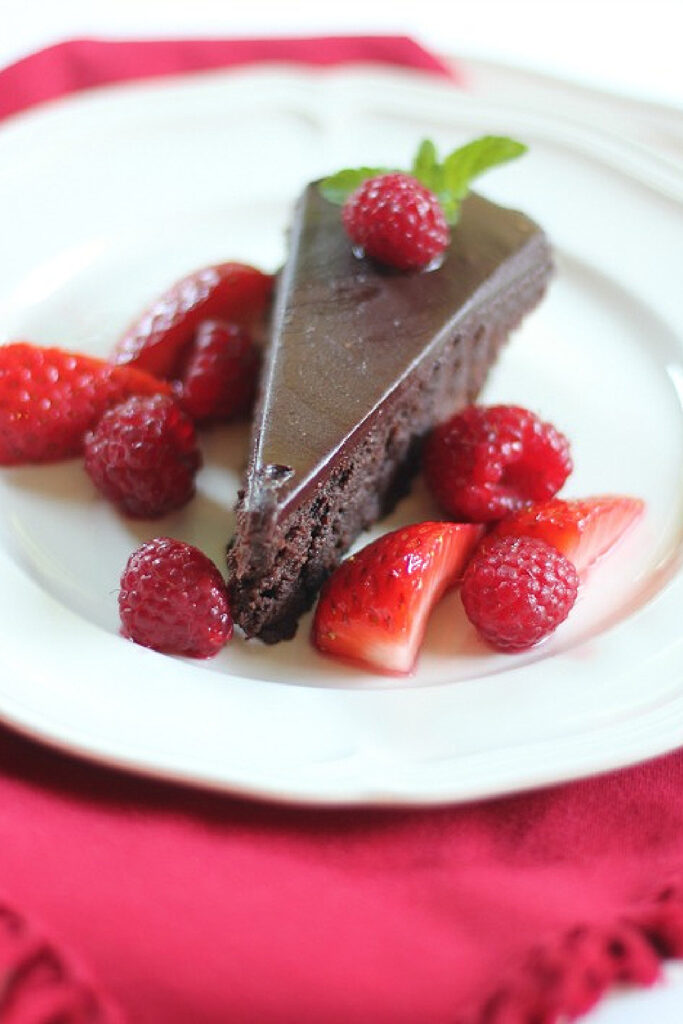 slice of Chocolate Cassis Cake with raspberries and strawberries