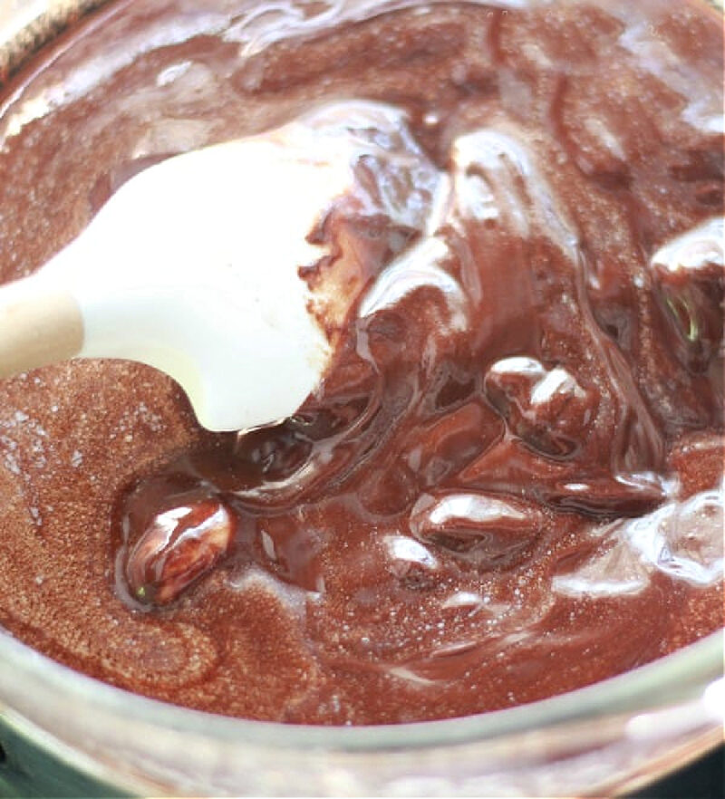 mixing chocolate glaze with white spatula