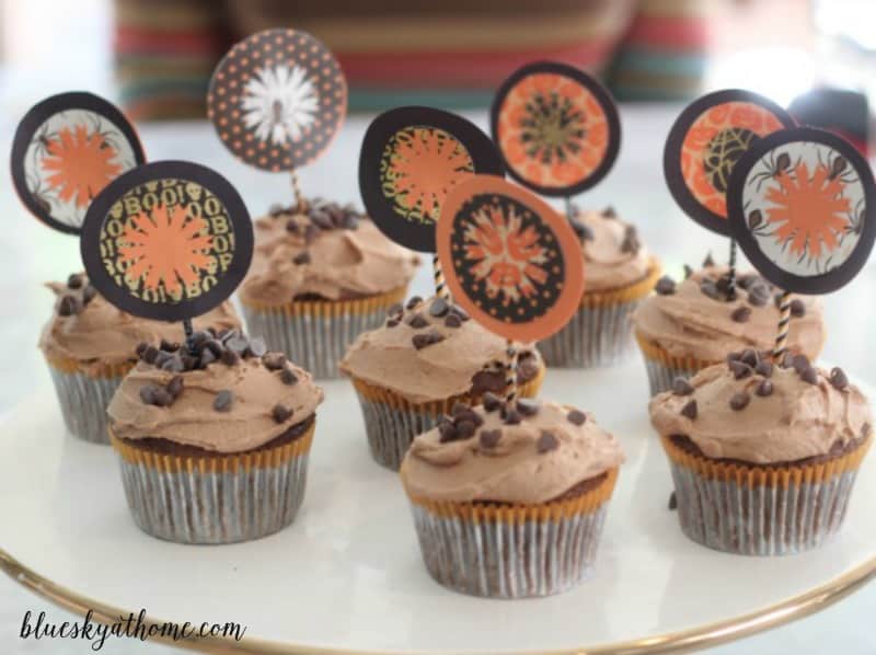 How to Make a Decorative Halloween Cupcake Topper using paper, glue, a paper cutter, decorative cutter, toothpicks and imagination.