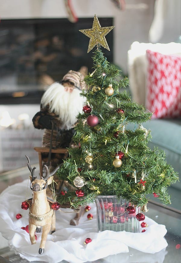 How Our Holiday Home Sparkles and Shines for Christmas with lights and ornaments in gold and silver with reindeer, Santas and snowmen.