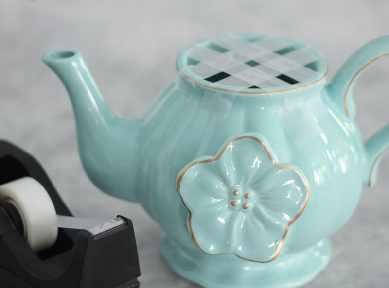 aqua teapot with crisscross scotch tape