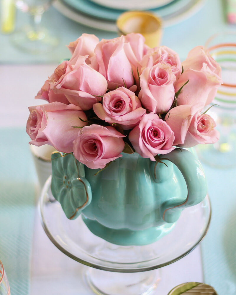 aqua teapot with pale pink flowers on spring tablescape