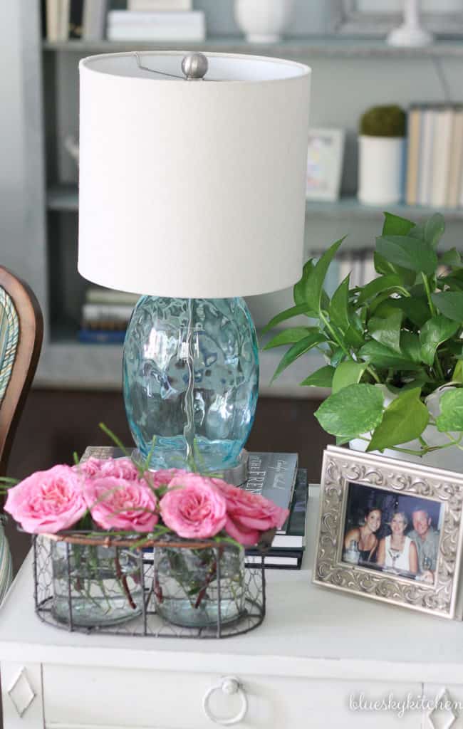 aqua lamp and pink roses on table