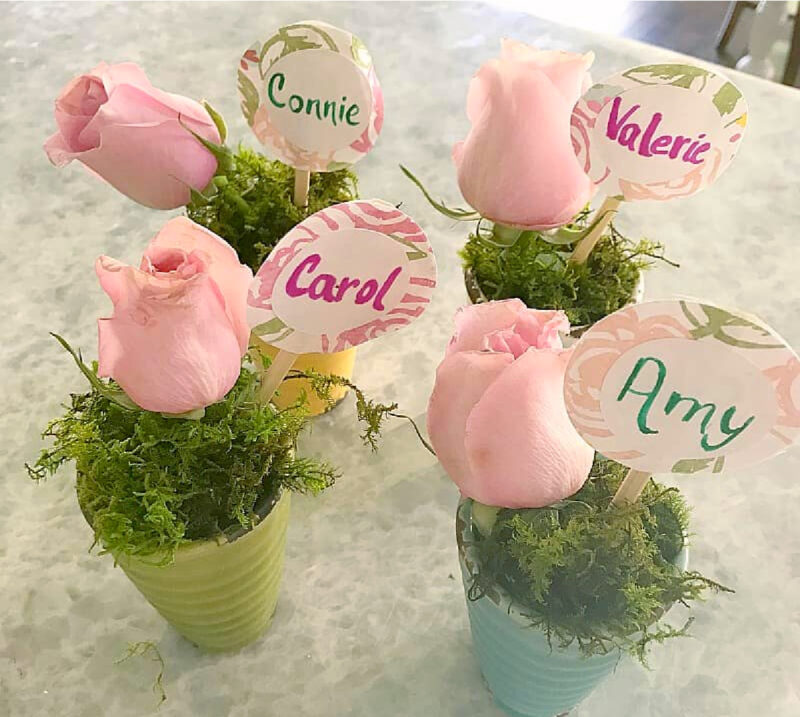 four floral place cards with pale pink roses