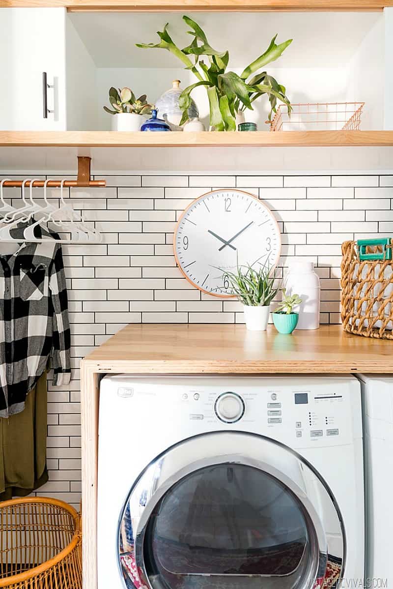 laundry room with countertop and tile wall