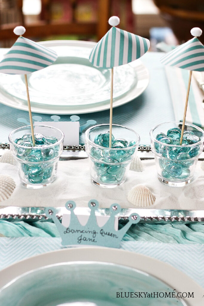 aqua glass in votices on for Mamma Mia! tablescape