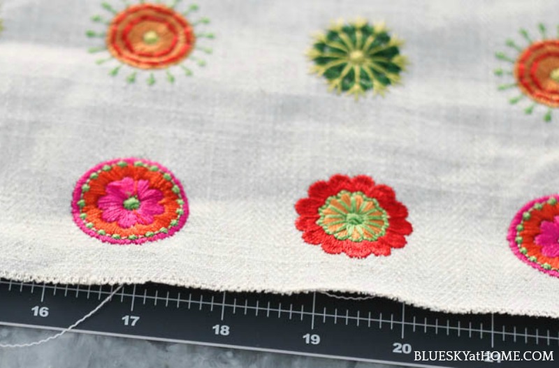 zipper and pink, green, orange embroidery circles on cream background