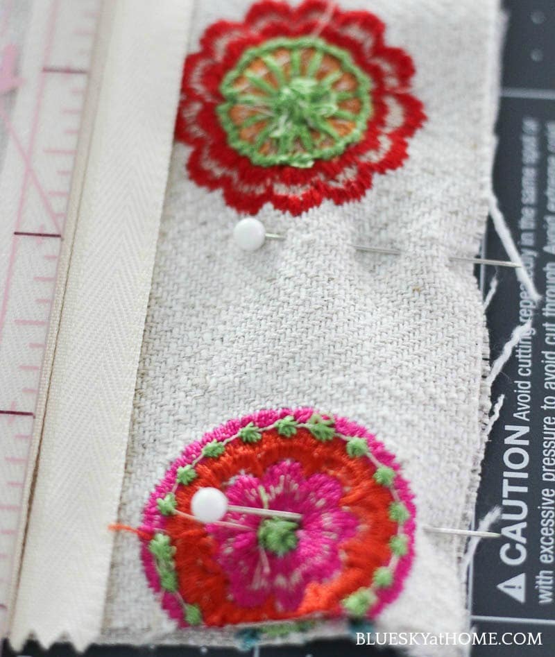 zipper and pink, green, orange embroidery circles on cream background