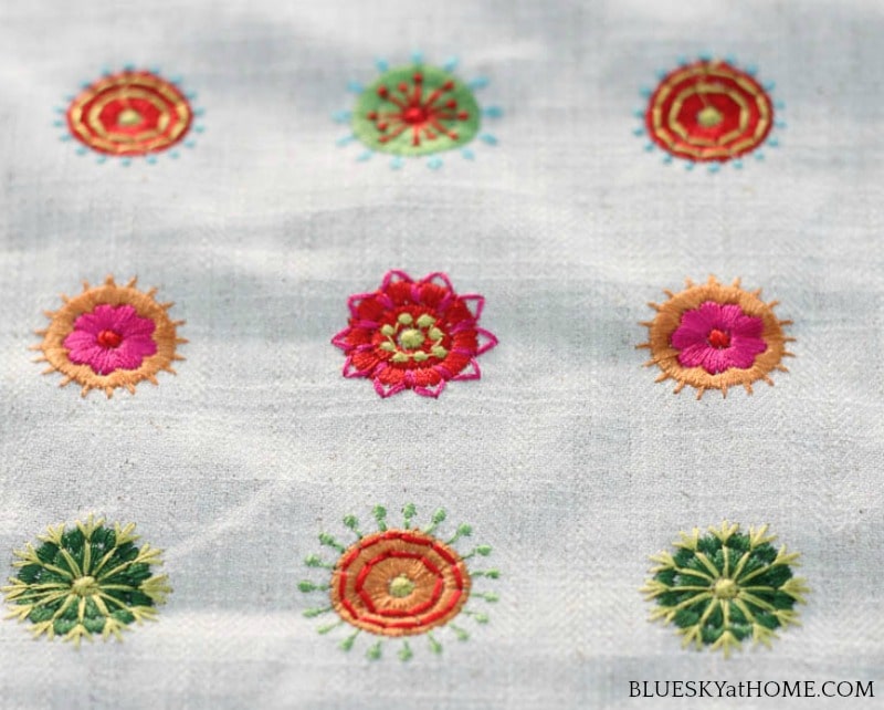 pink, green, orange embroidery circles on cream background