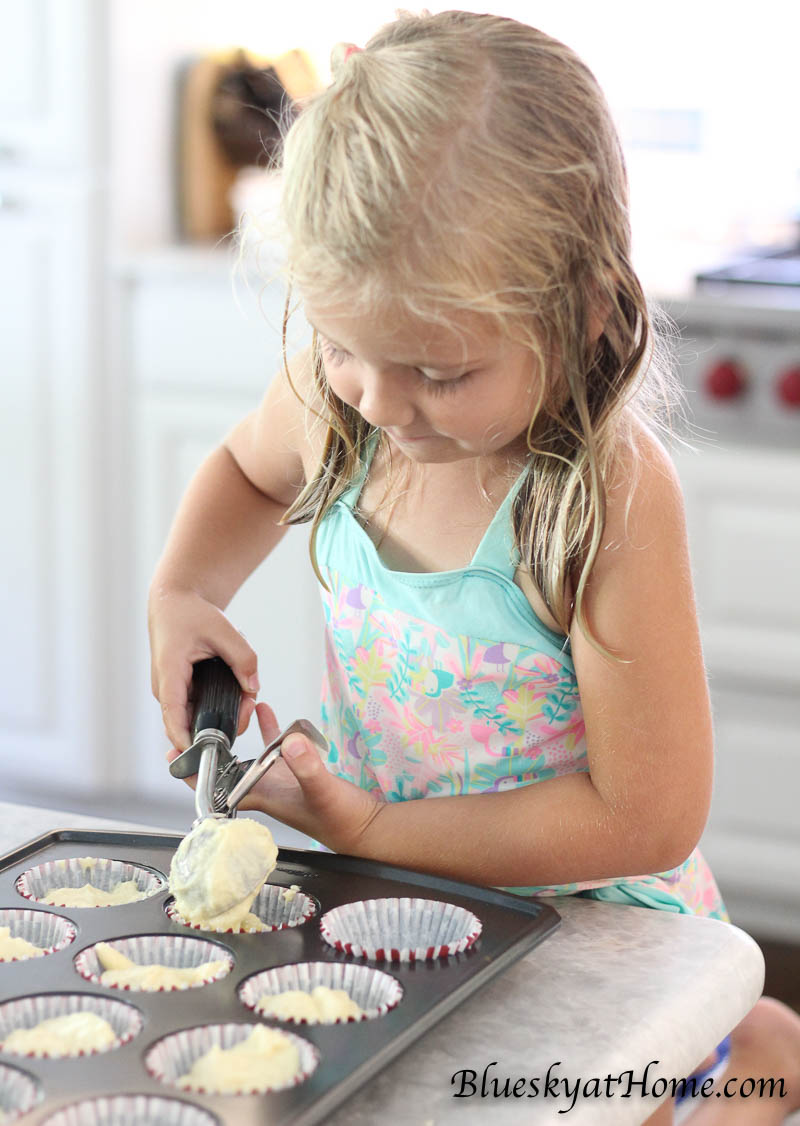 little girl making cupcakes