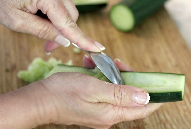 removing seeds from cucumber for making Cucumber Tomatillo Gazpacho