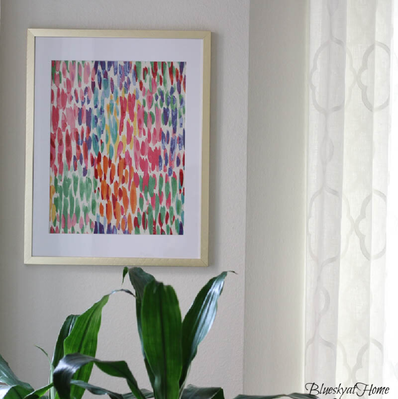 bright colored fabric in gold frame