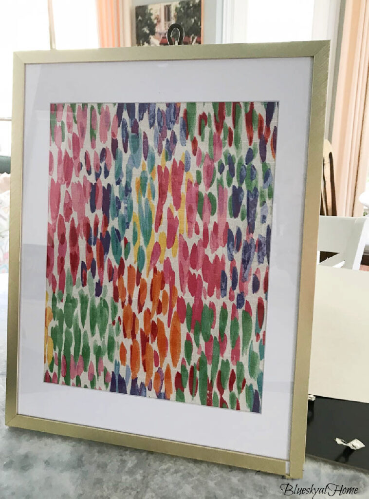 bright colored fabric in gold frame