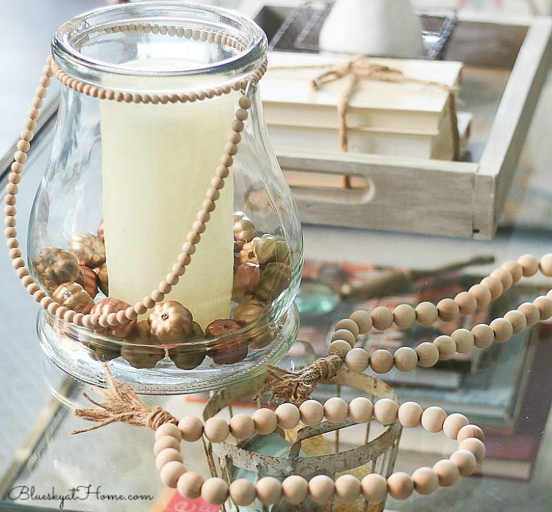 coffee table with beads,candle, and tray