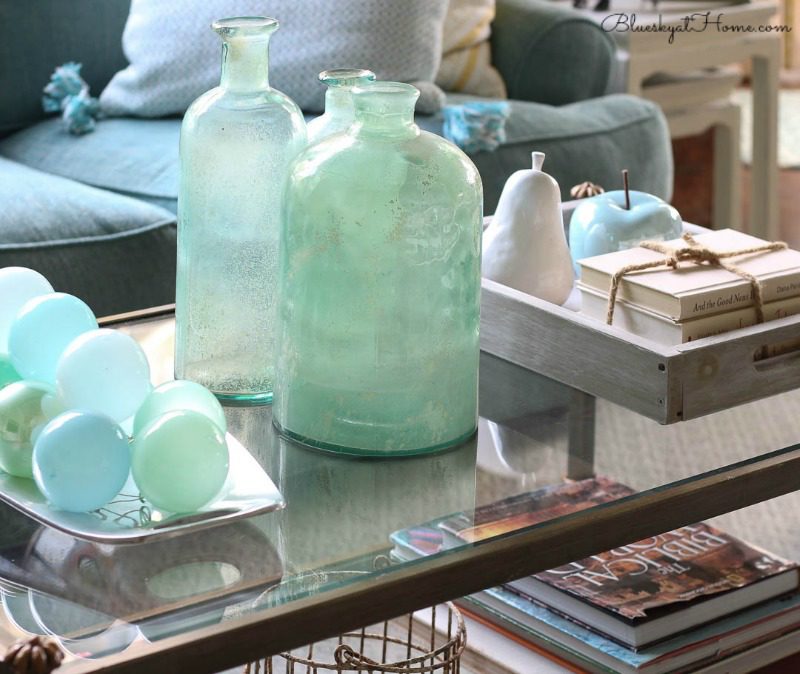 coffee table with green glass jars