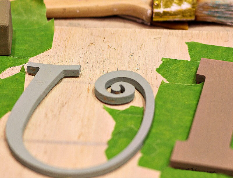 wood letters on piece of plywood