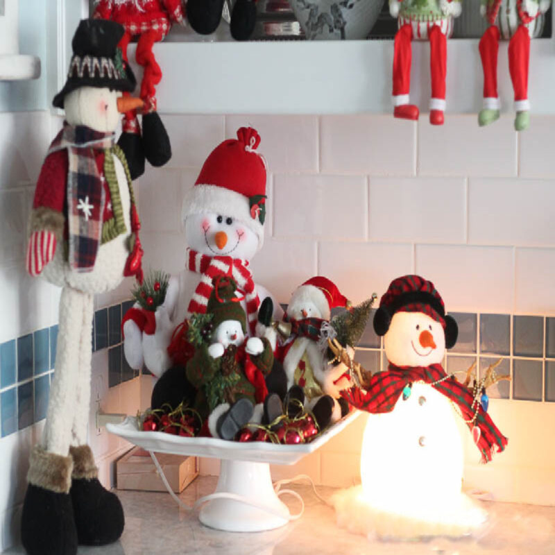 festive Christmas vignette with Christmas figures on a white cake stand