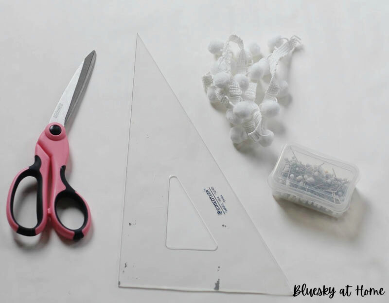 scissors, white pom-poms and straight edge