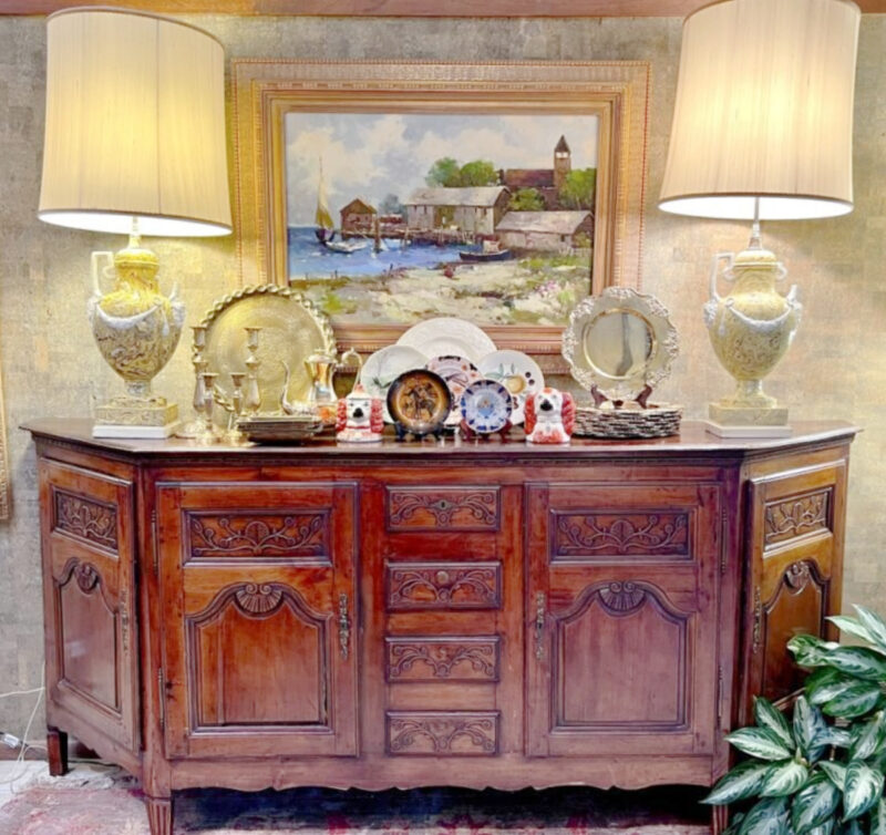 credenza with lamps and decorative accesories.