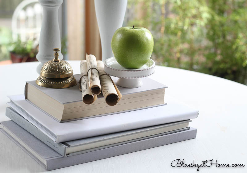 books, candles, bell vignette