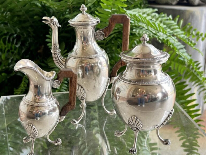 three vintage silver pitchers with wood handles