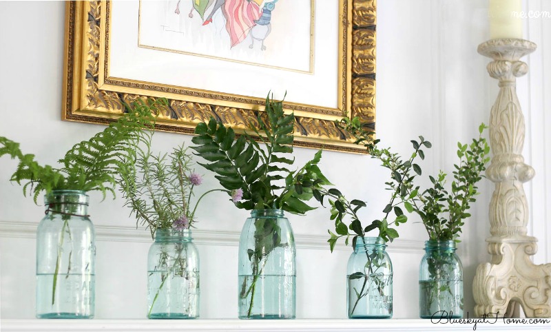 green in mason jars on mantle