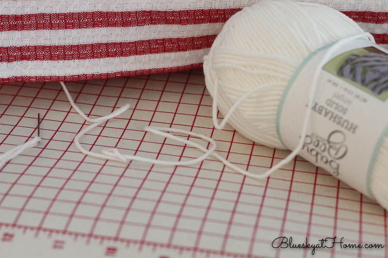 white yarn to make no-sew pillow with dishtowels