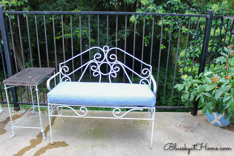 white bench with blue cushion