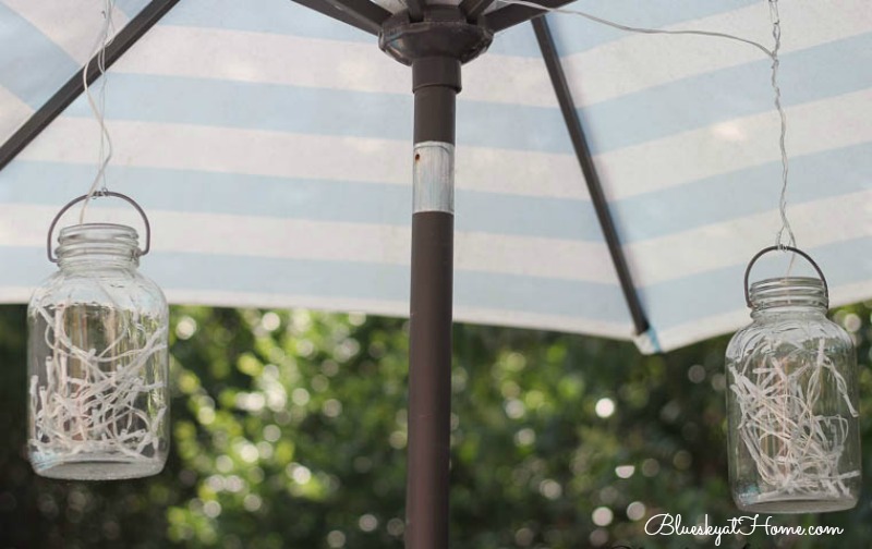 outdoor mason jar lighting hanging from umbrella