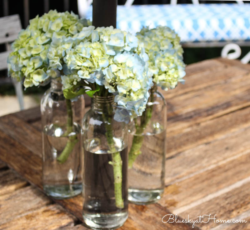 blue hydrangeas in glass bottles