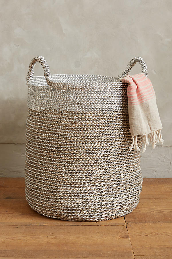 woven basket in tan and white on floor