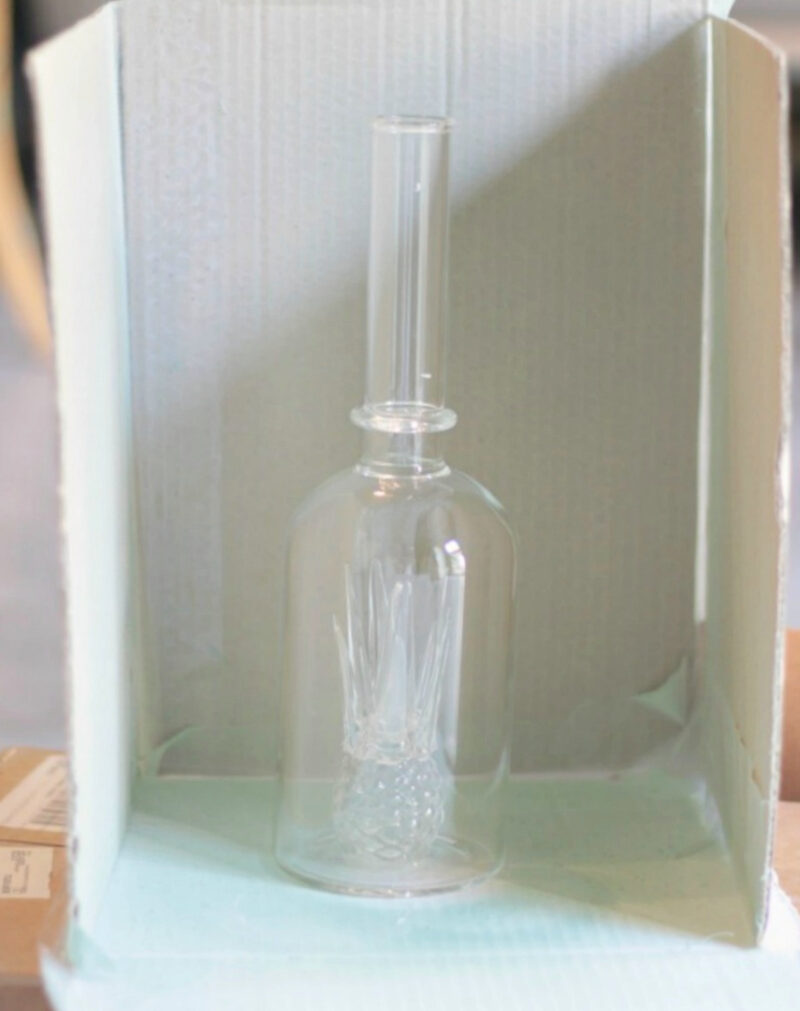clear glass liqueur bottle in paint bow