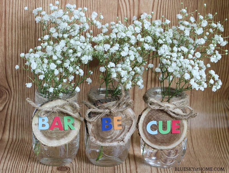 white flowers in mason jars