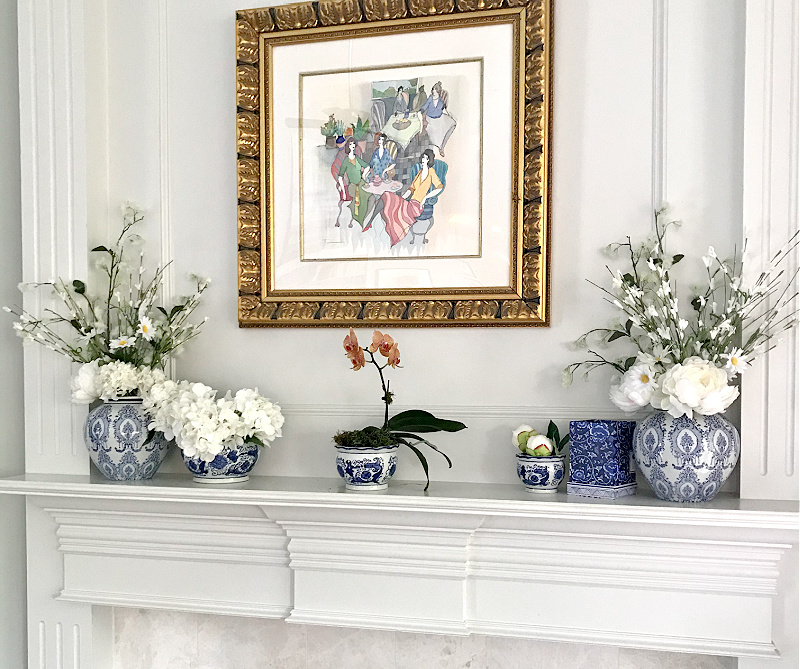 blue and white vases on white mantel