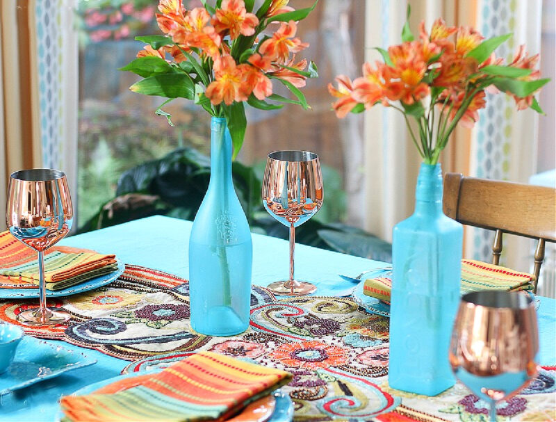 fall tablescape in aqua and oranges with sea glass bottles