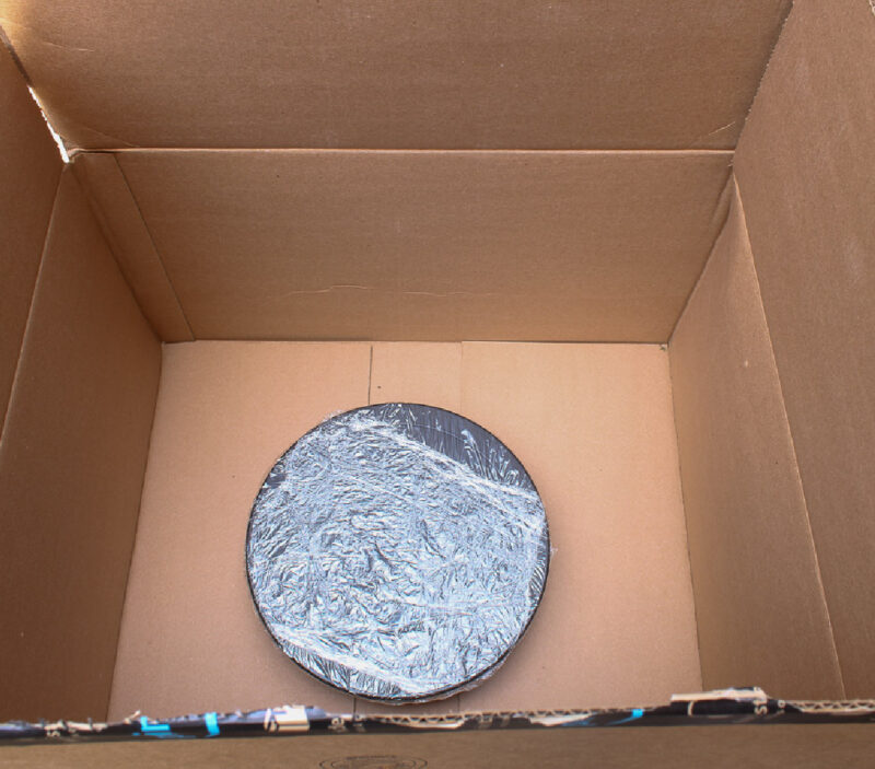 lazy susan covered in plastic in cardboard box for painting