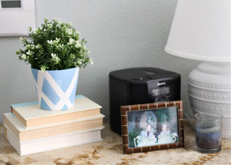 nightstand with lamp on stack of books