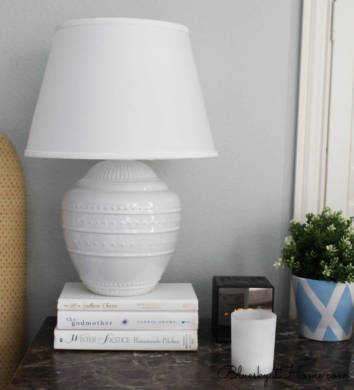 white lamp on stack of books